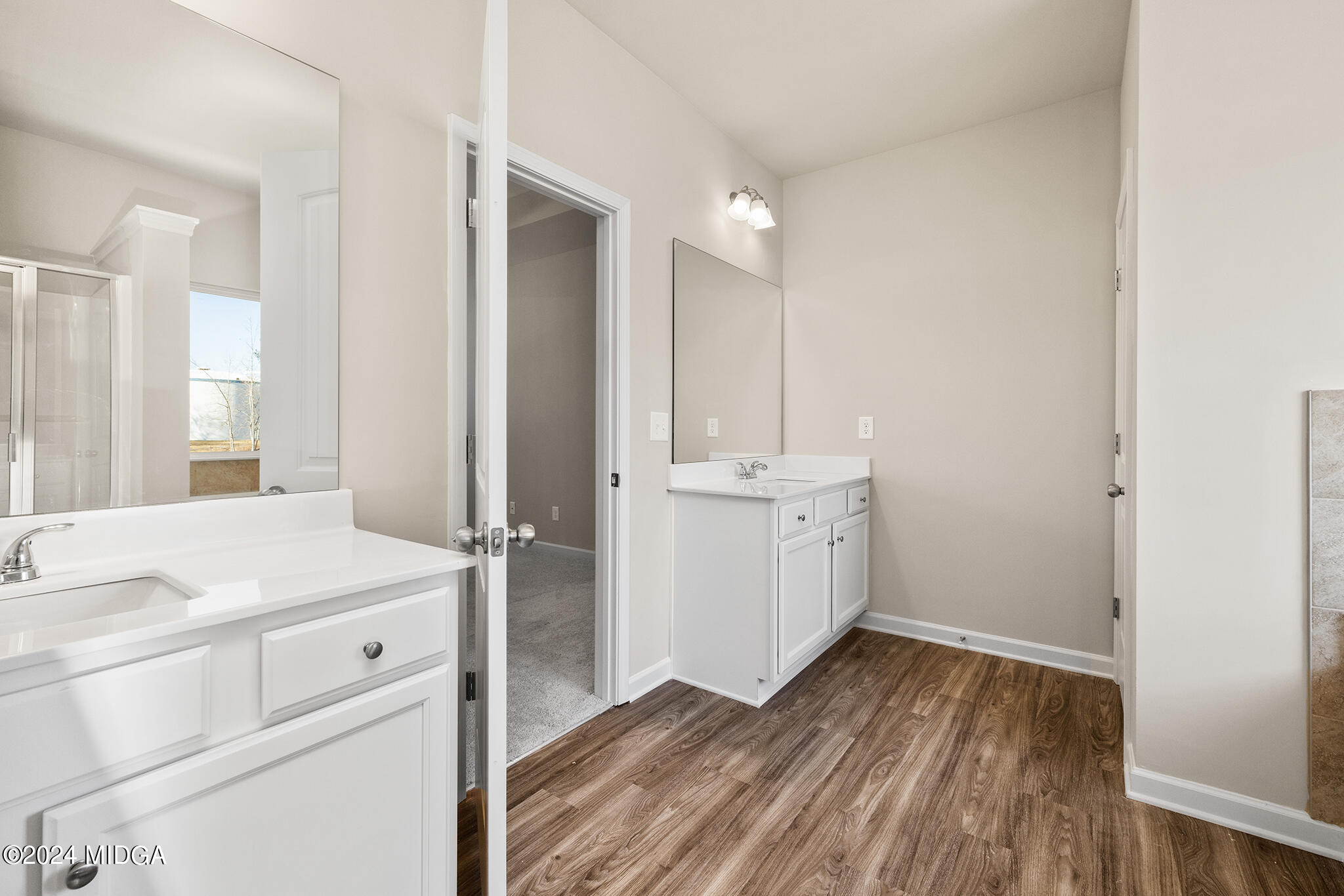 499 Grand Magnolia Street Jackson, GA 30233 - Photo 22 of 35 a bathroom with a sink a mirror and a shower
