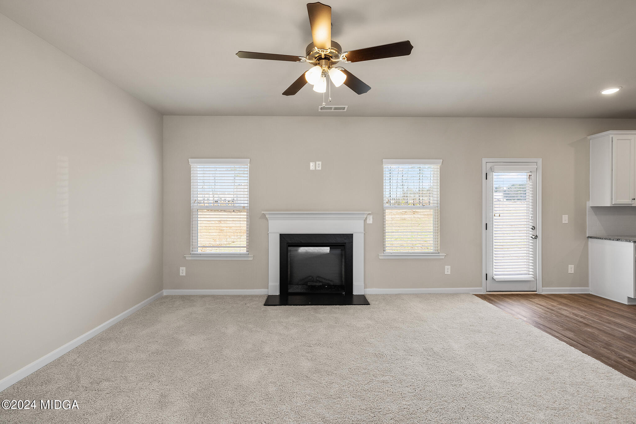 499 Grand Magnolia Street Jackson, GA 30233 - Photo 8 of 35 a view of a windows and chandelier fan in an empty room