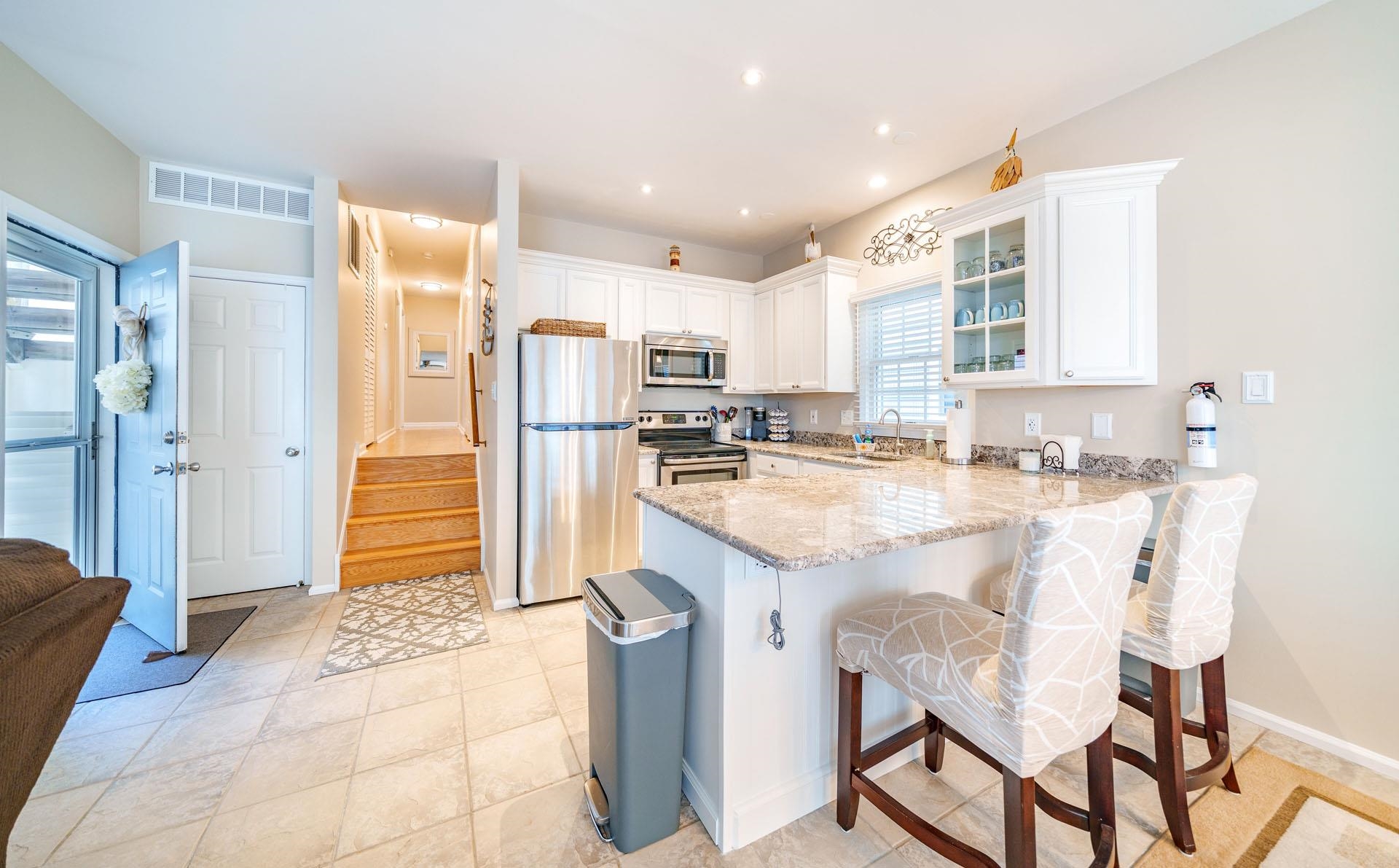 3824 Asbury Avenue, Unit 1 Ocean City, NJ 08226 - Photo 15 of 40 a kitchen with granite countertop a refrigerator and cabinets