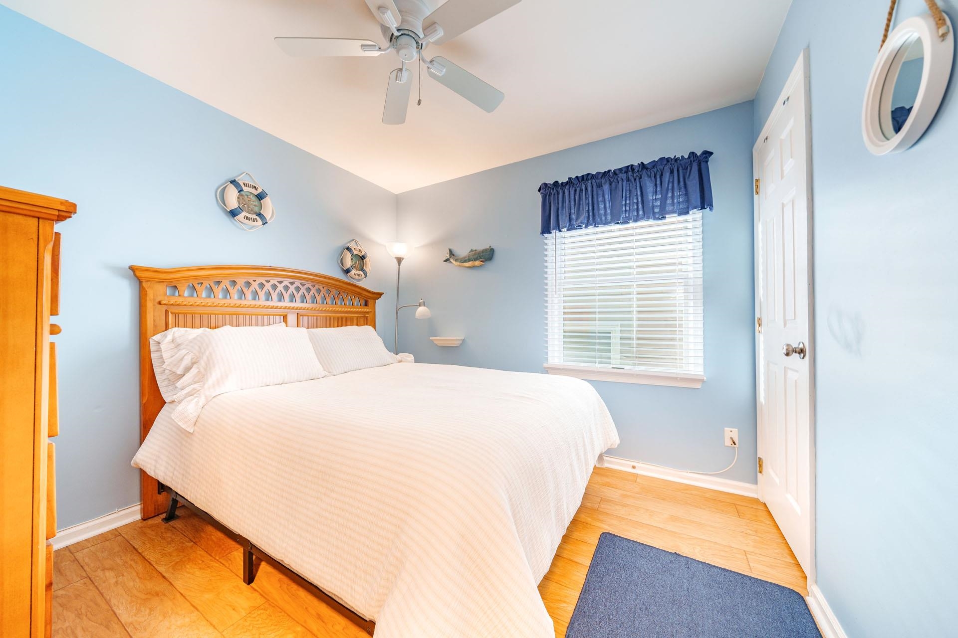 3824 Asbury Avenue, Unit 1 Ocean City, NJ 08226 - Photo 18 of 40 a bedroom with a bed and a chandelier