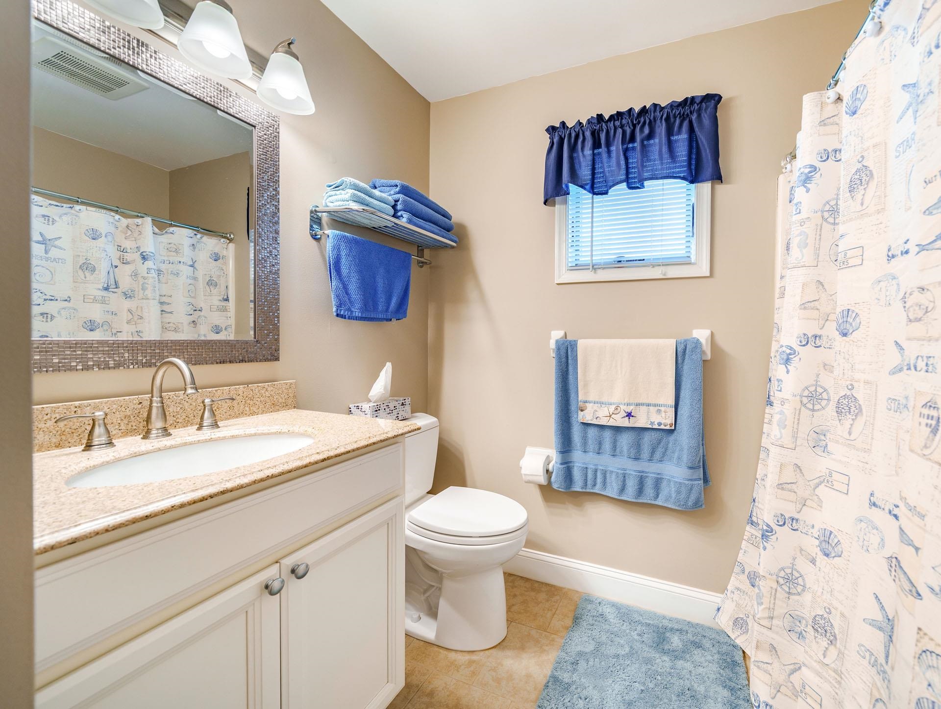 3824 Asbury Avenue, Unit 1 Ocean City, NJ 08226 - Photo 20 of 40 a bathroom with a sink a toilet and a mirror