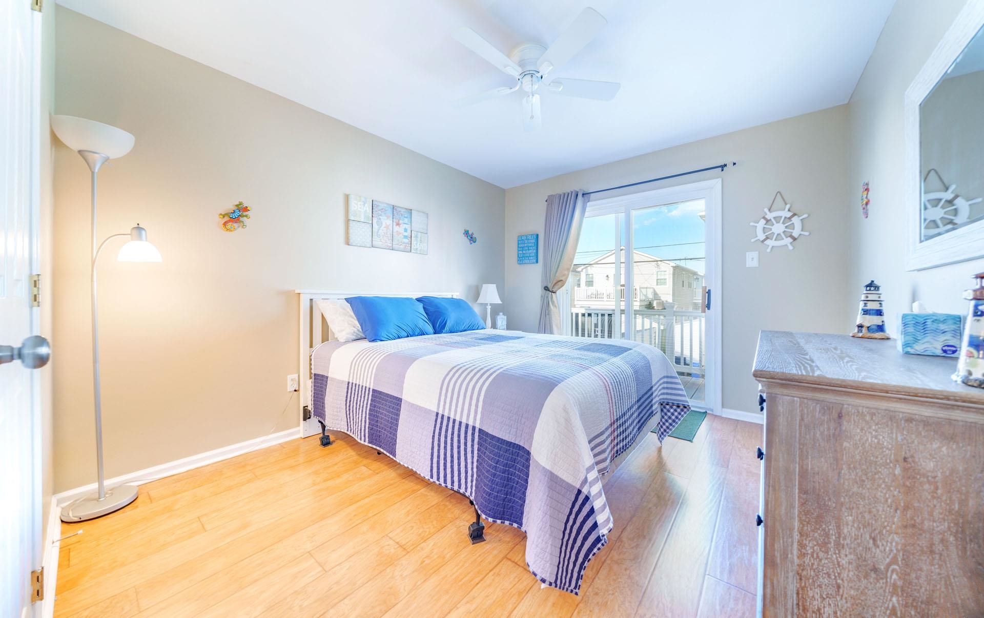 3824 Asbury Avenue, Unit 1 Ocean City, NJ 08226 - Photo 21 of 40 a spacious bedroom with a bed and a table in it