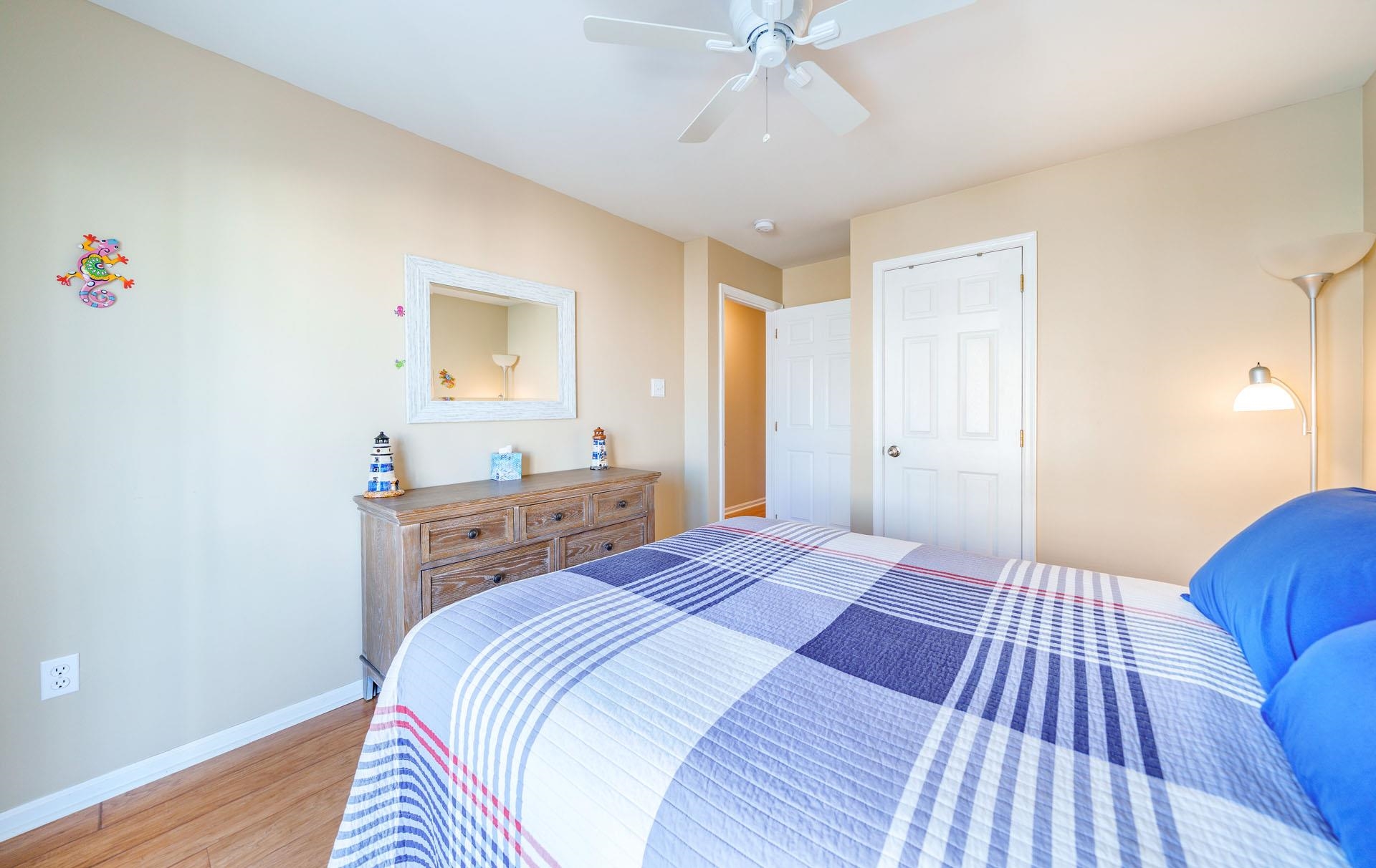 3824 Asbury Avenue, Unit 1 Ocean City, NJ 08226 - Photo 22 of 40 a bedroom with a bed and a dresser