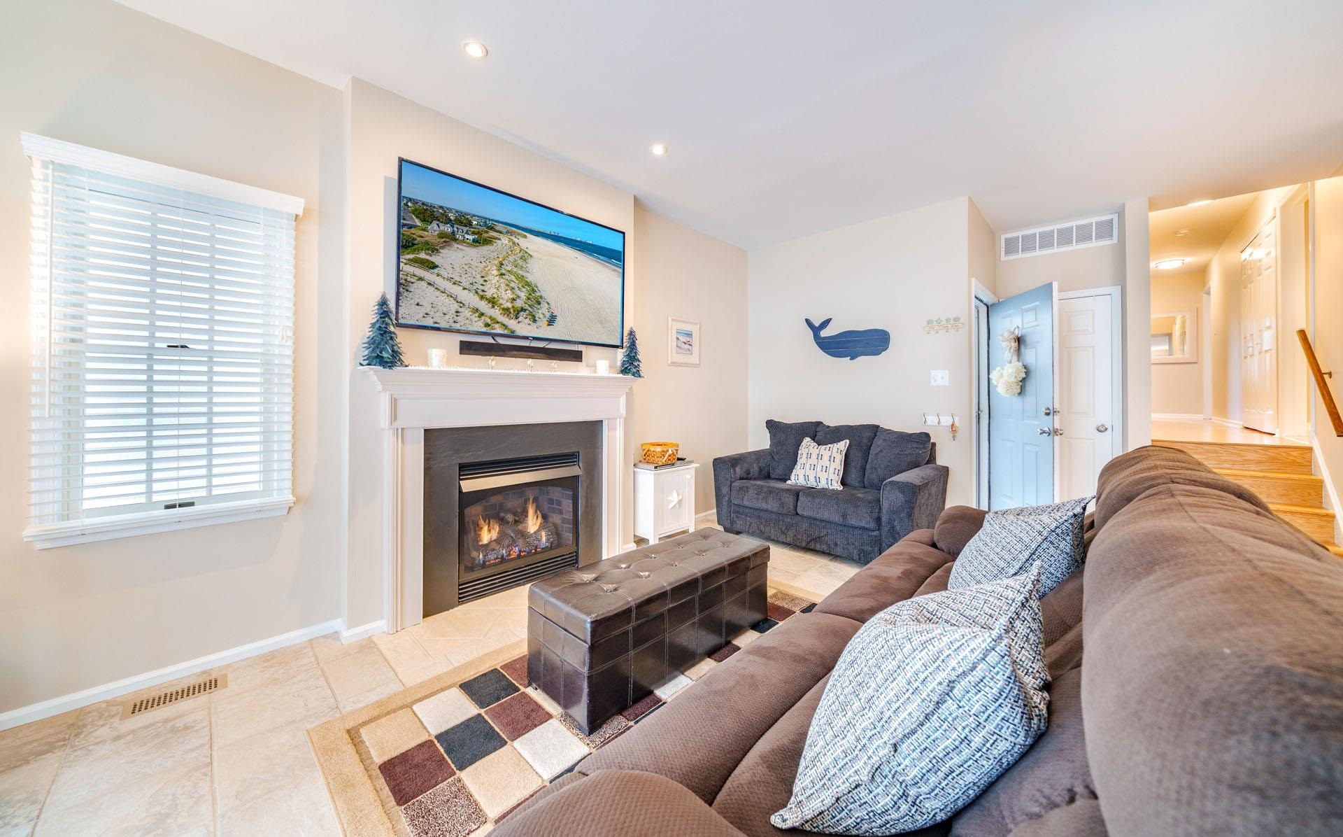 3824 Asbury Avenue, Unit 1 Ocean City, NJ 08226 - Photo 4 of 40 a living room with furniture a window and a fireplace