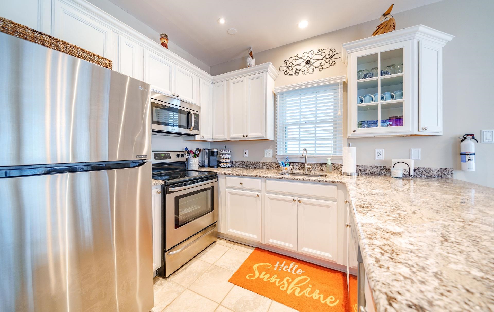 3824 Asbury Avenue, Unit 1 Ocean City, NJ 08226 - Photo 9 of 40 a kitchen with stainless steel appliances granite countertop a refrigerator sink and stove