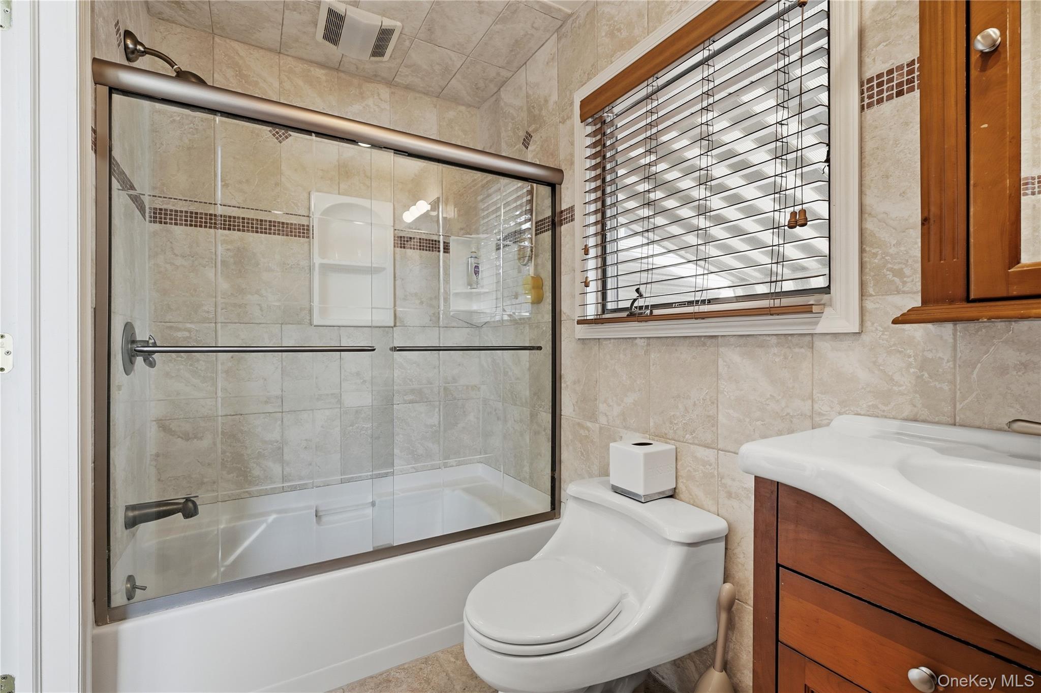 1853 Decatur Avenue Merrick, NY 11566 - Photo 29 of 43 a bathroom with a sink and a toilet