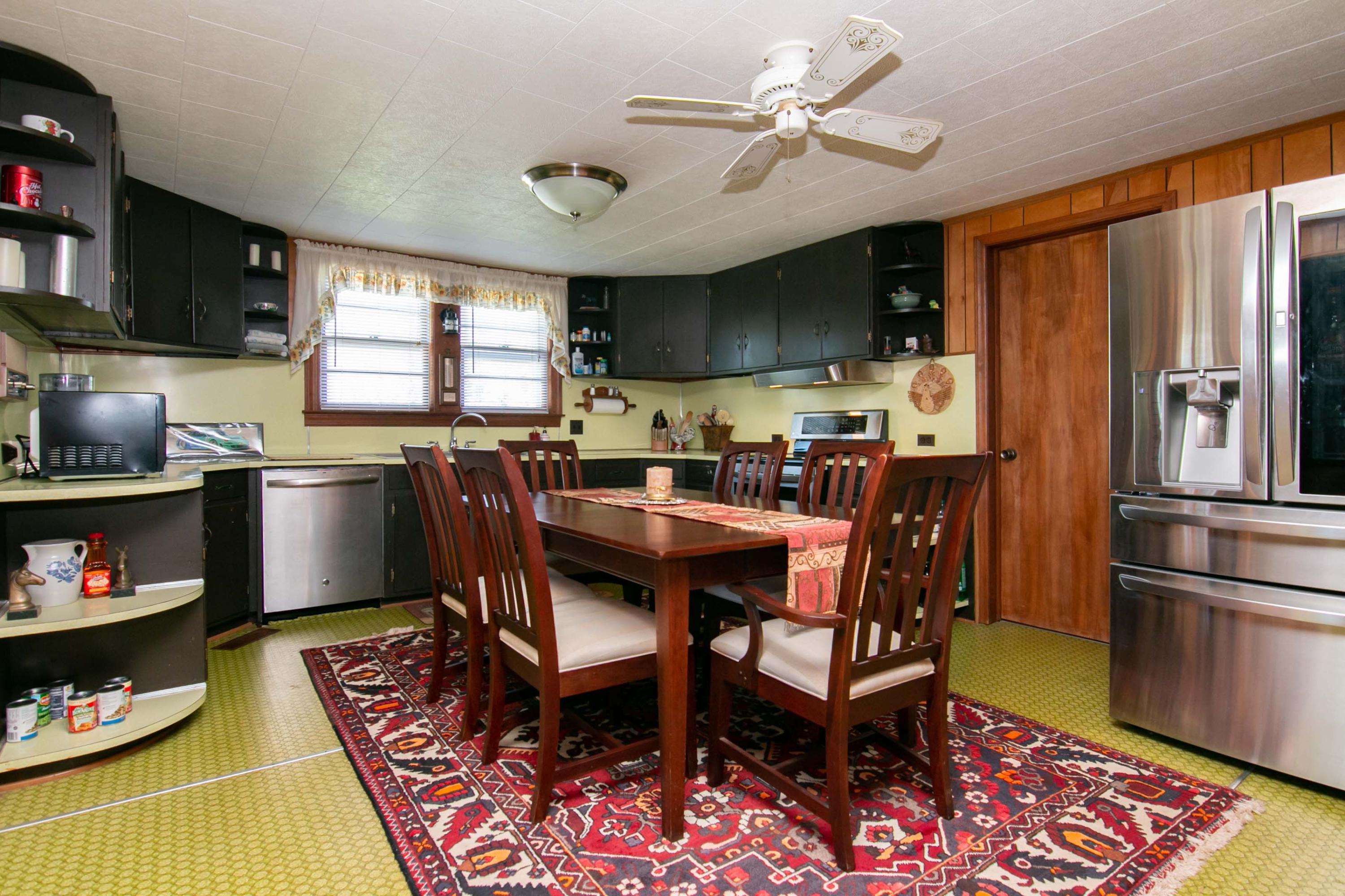 3257 Sago Road Chatham, VA 24531 - Photo 30 of 94 a kitchen with stainless steel appliances granite countertop a dining table chairs refrigerator and sink