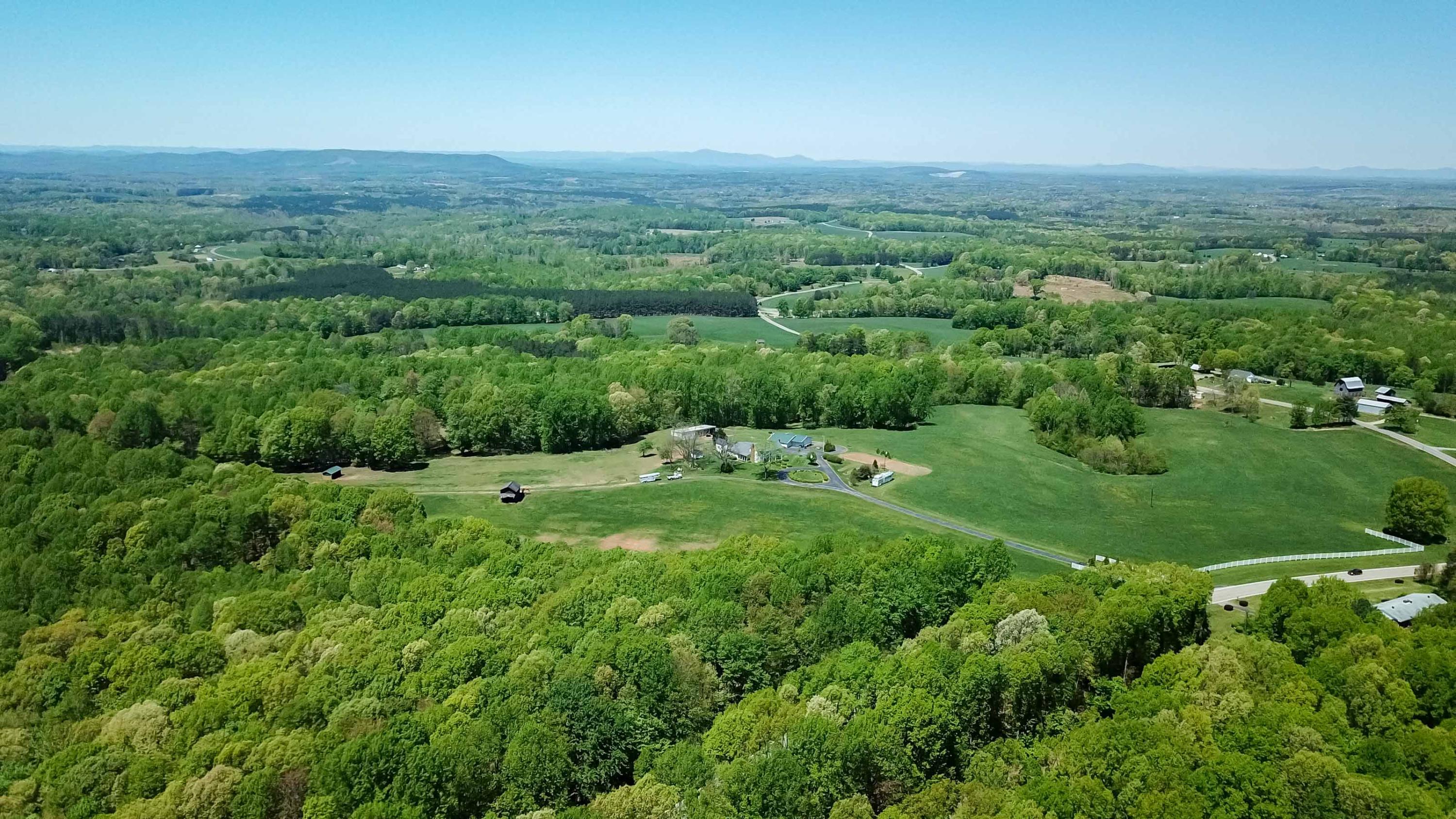 3257 Sago Road Chatham, VA 24531 - Photo 92 of 94 a view of a lush green outdoor space with a swimming pool and valleys in the background