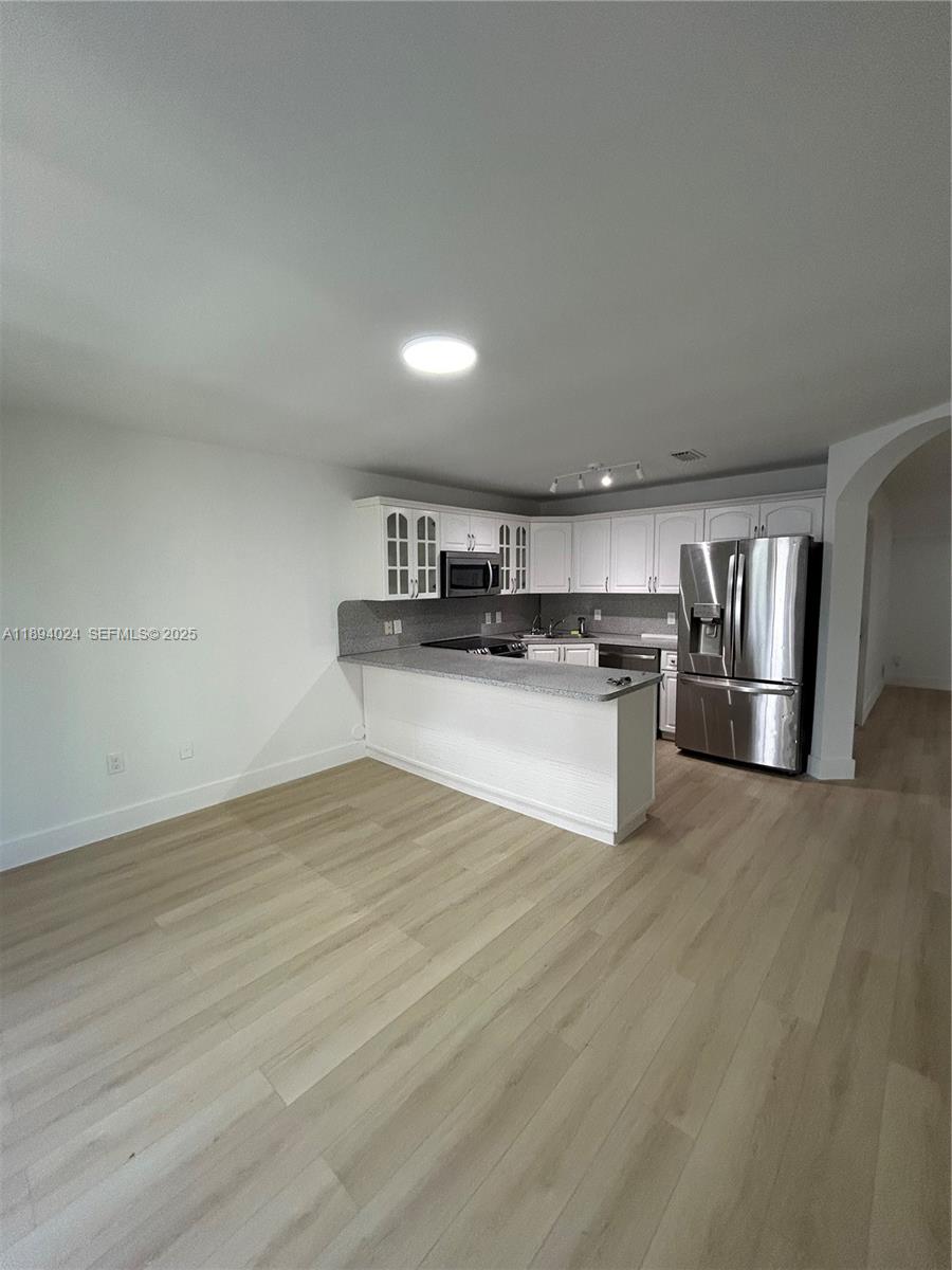 8725 Southwest 158th Place Miami, FL 33193 - Photo 14 of 53 a view of kitchen with wooden floor