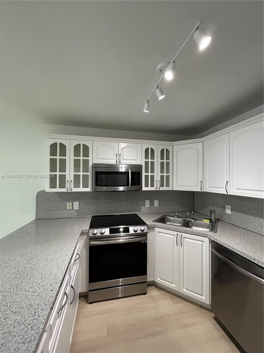 8725 Southwest 158th Place Miami, FL 33193 - Photo 19 of 53 a kitchen with a stove and a sink