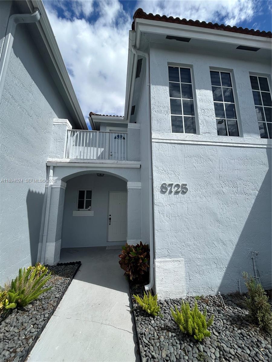 8725 Southwest 158th Place Miami, FL 33193 - Photo 2 of 53 a front view of a house with garden