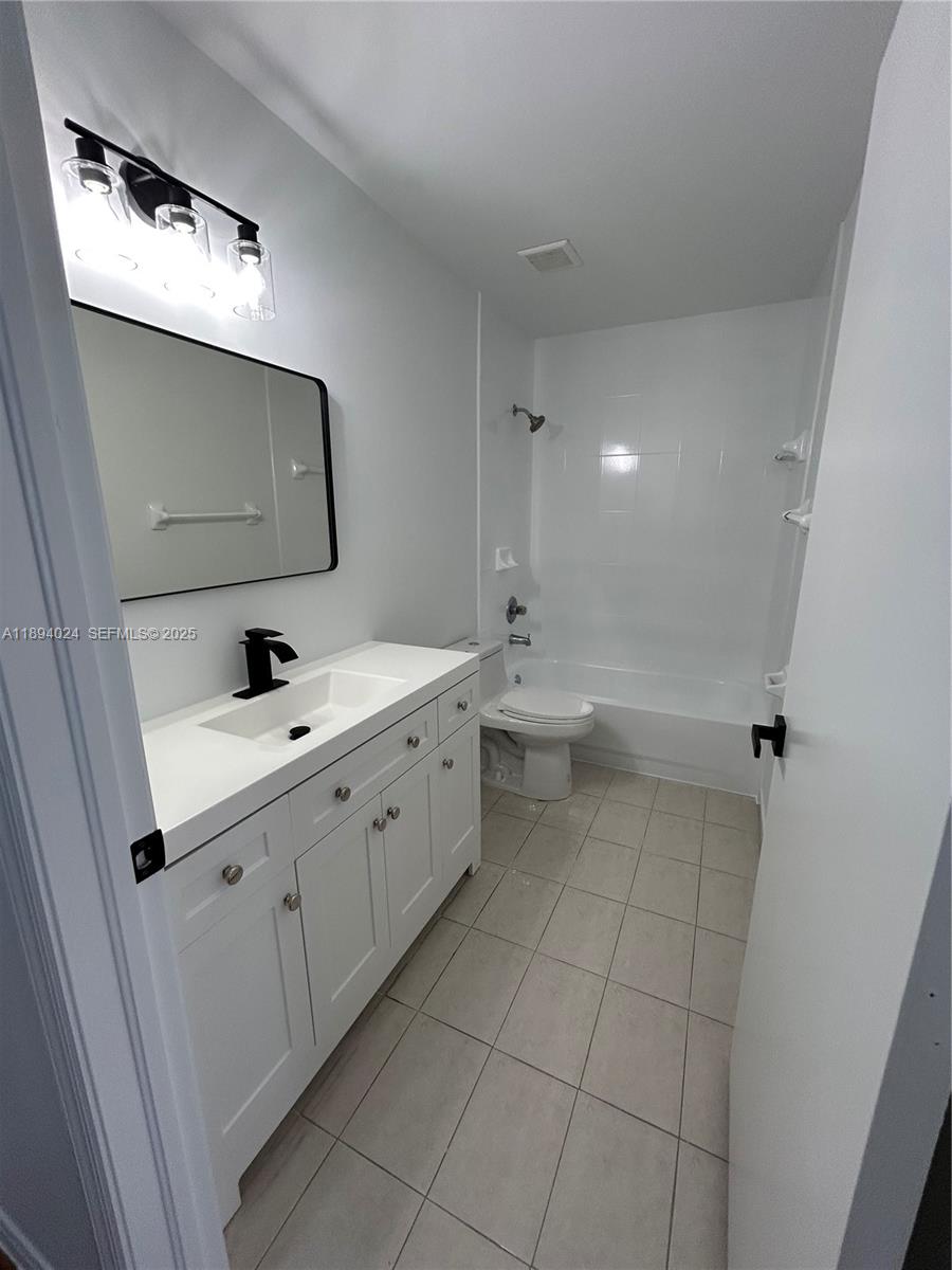 8725 Southwest 158th Place Miami, FL 33193 - Photo 35 of 53 a bathroom with a double vanity sink toilet and mirror