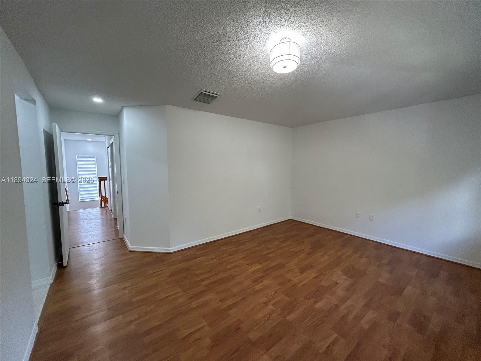 8725 Southwest 158th Place Miami, FL 33193 - Photo 39 of 53 a view of empty room with wooden floor