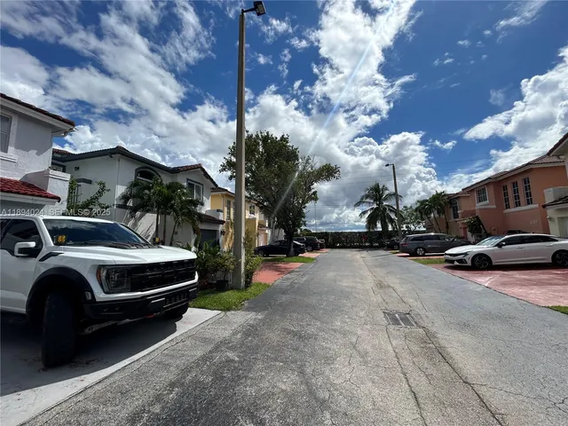 a view of street with parked cars