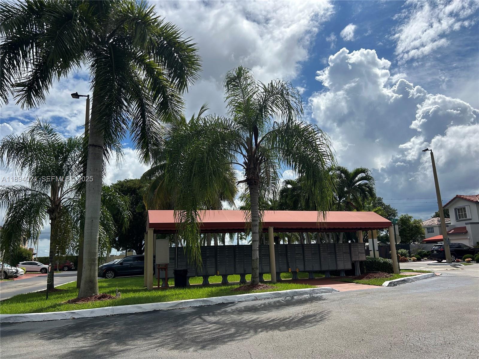 8725 Southwest 158th Place Miami, FL 33193 - Photo 51 of 53 a front view of a building with palm trees