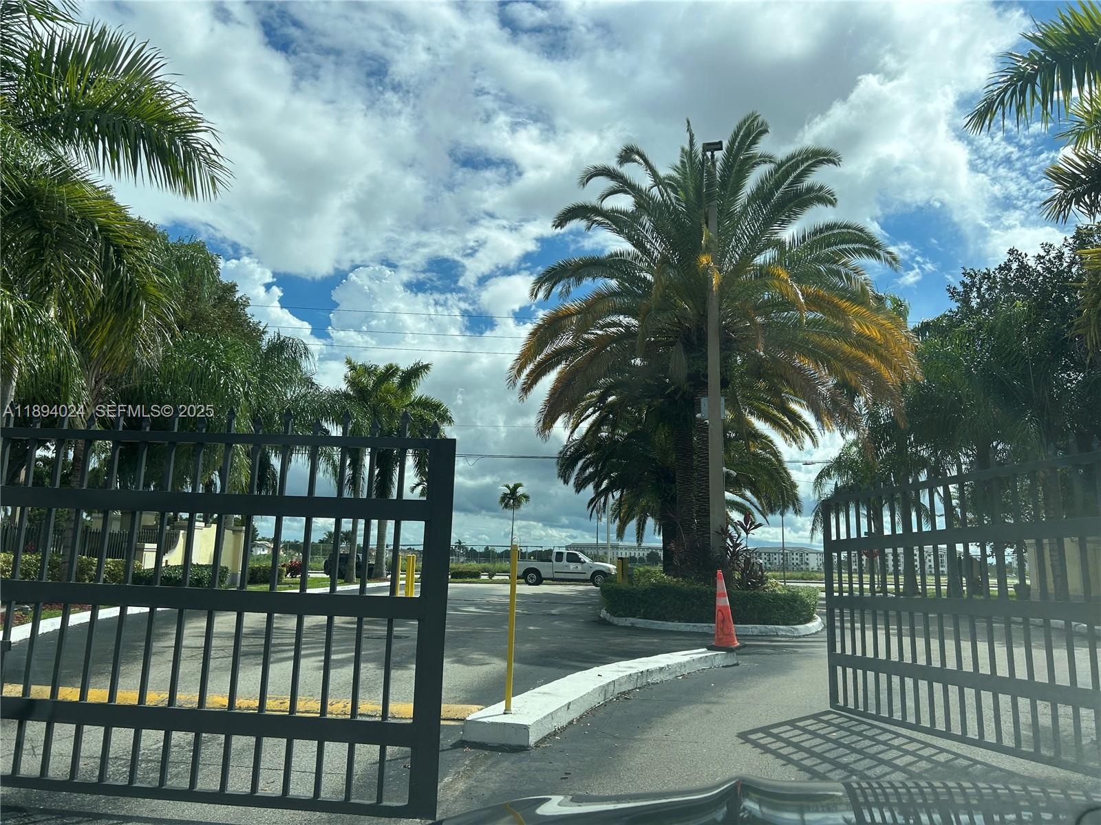 8725 Southwest 158th Place Miami, FL 33193 - Photo 52 of 53 a view of outdoor space with swimming pool and trees