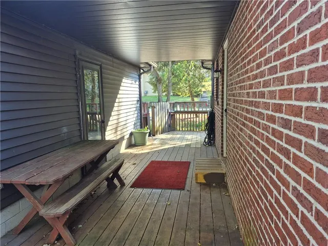 a view of a patio with wooden floor