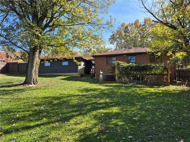 a view of a house with a backyard