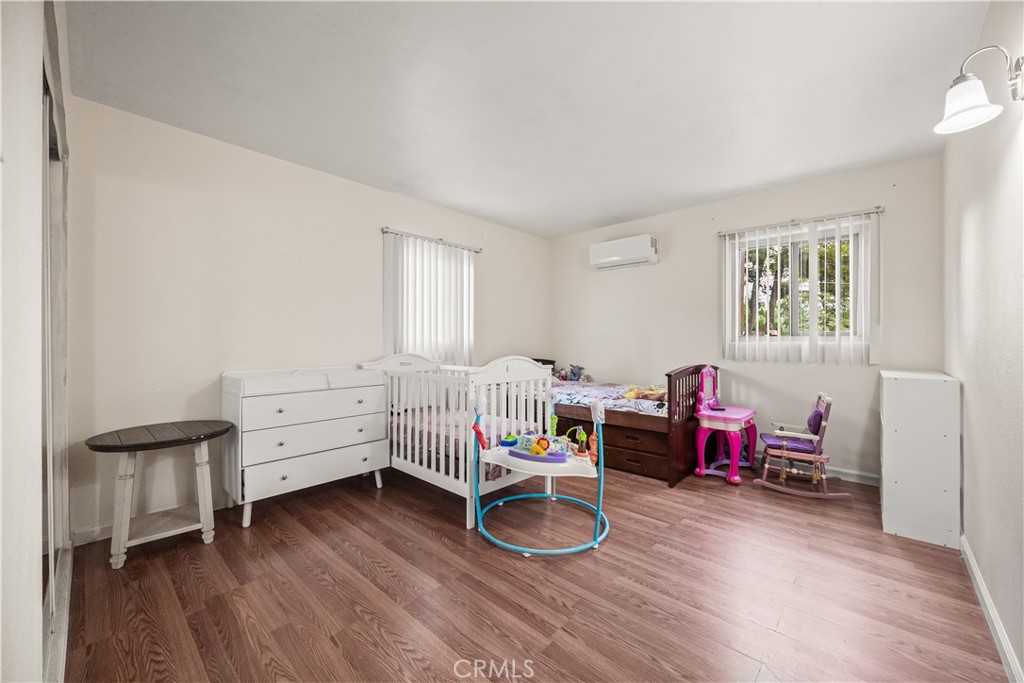 680 North 10th Street Banning, CA 92220 - Photo 15 of 24 a bedroom with furniture and a wooden floor
