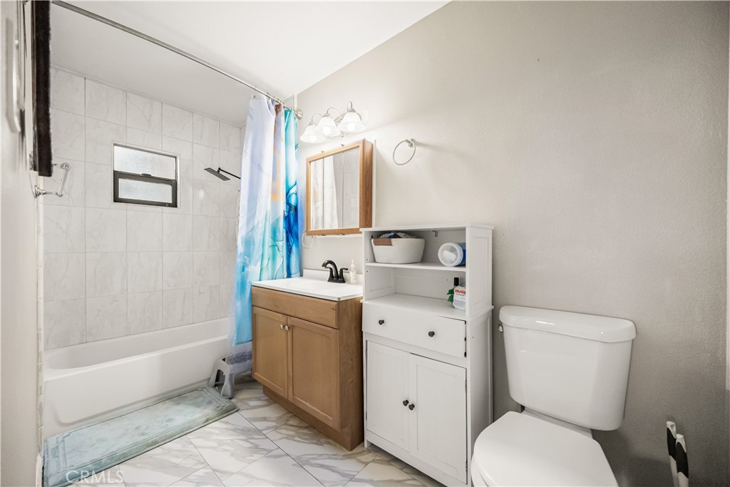 680 North 10th Street Banning, CA 92220 - Photo 18 of 24 a bathroom with a toilet sink and mirror