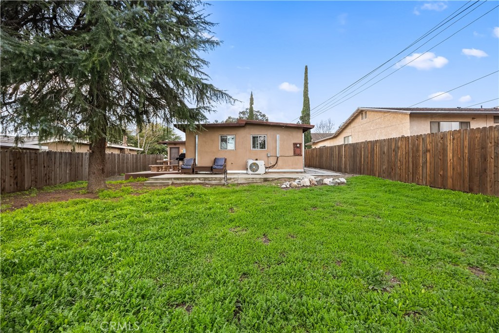 680 North 10th Street Banning, CA 92220 - Photo 20 of 24 a view of a backyard with table and chairs and wooden fence