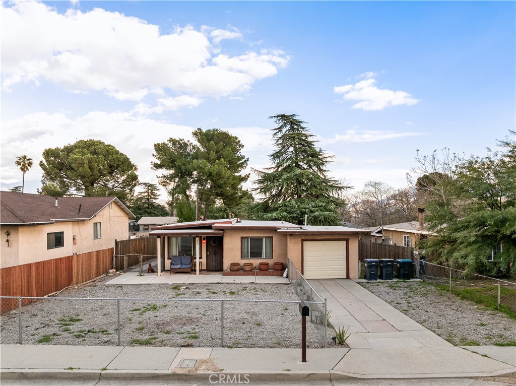 680 North 10th Street Banning, CA 92220 - Photo 2 of 24 a front view of a house with a garden