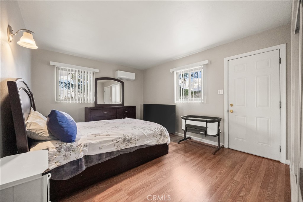 680 North 10th Street Banning, CA 92220 - Photo 9 of 24 a bedroom with a bed and wooden floor