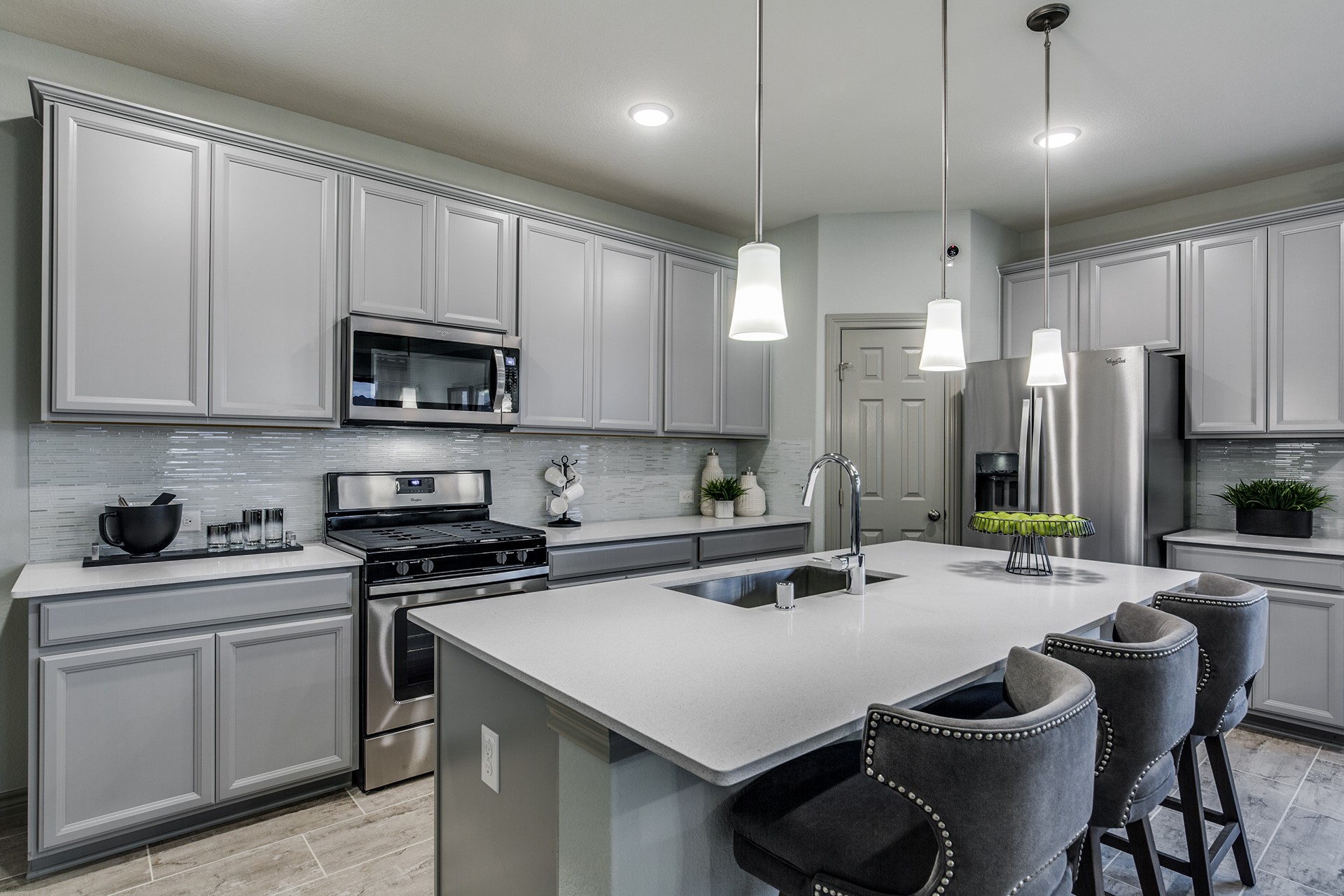 15638 Wandering Maple Way Conroe, TX 77302 - Photo 3 of 20 a kitchen with a sink a stove and chairs