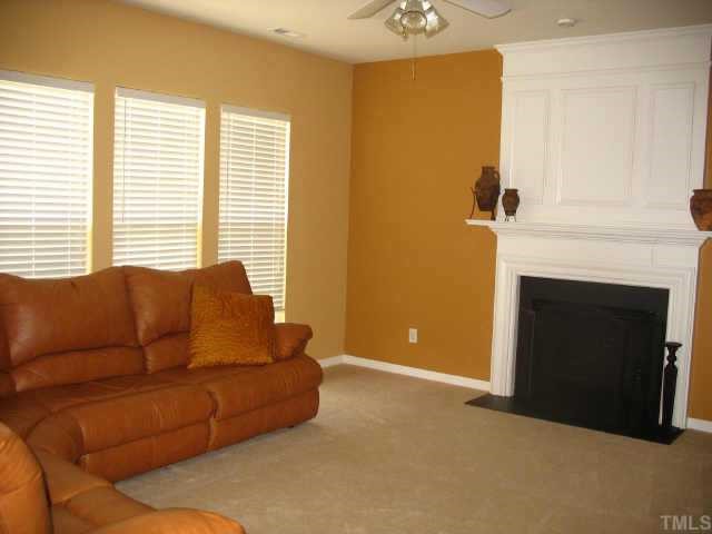 7420 Silver View Lane Raleigh, NC 27613 - Photo 3 of 10 a living room with furniture and a fireplace