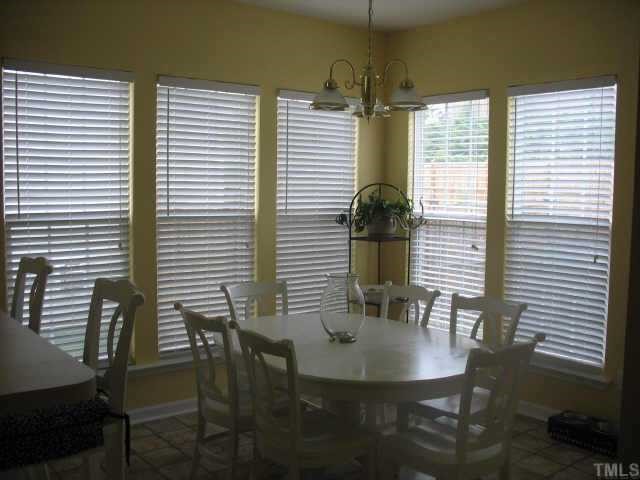 7420 Silver View Lane Raleigh, NC 27613 - Photo 4 of 10 a view of a dining room with furniture and wooden floor