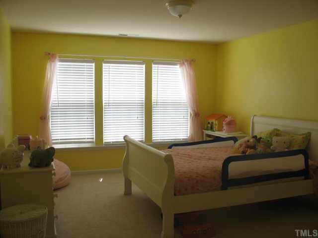 7420 Silver View Lane Raleigh, NC 27613 - Photo 6 of 10 a bedroom with a bed and window