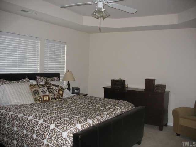 7420 Silver View Lane Raleigh, NC 27613 - Photo 7 of 10 a bedroom with a bed and a desk