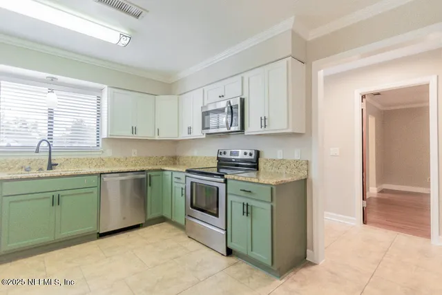 a view of a hallway to closet and utility room