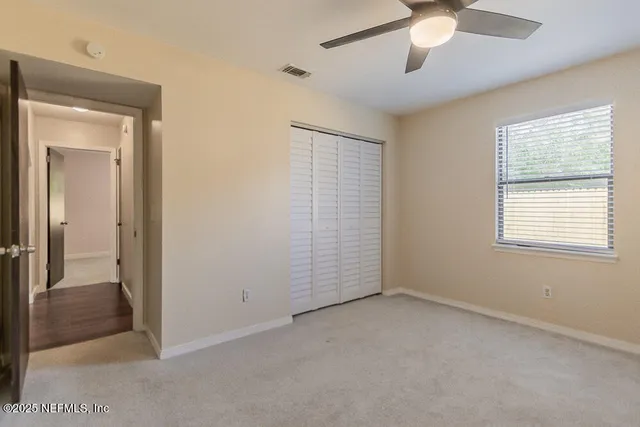 a view of staircase with wooden floor and white walls