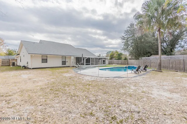 a view of a house with swimming pool and sitting area