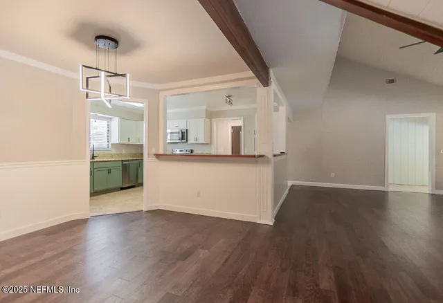 a view of a refrigerator in kitchen and wooden floor