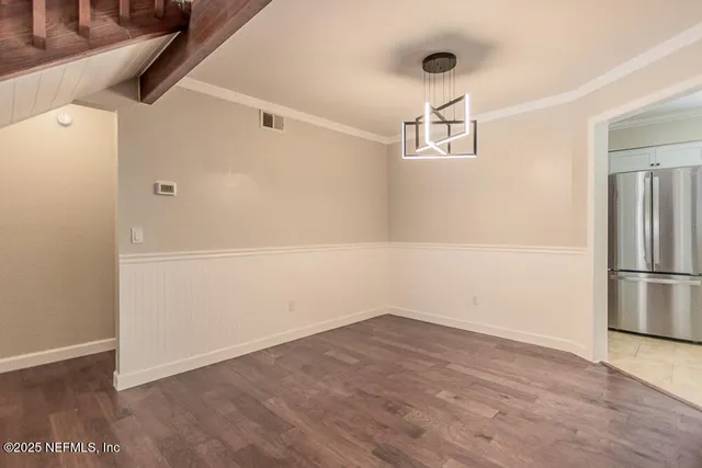 a view of a kitchen with wooden floor and a kitchen space with a sink