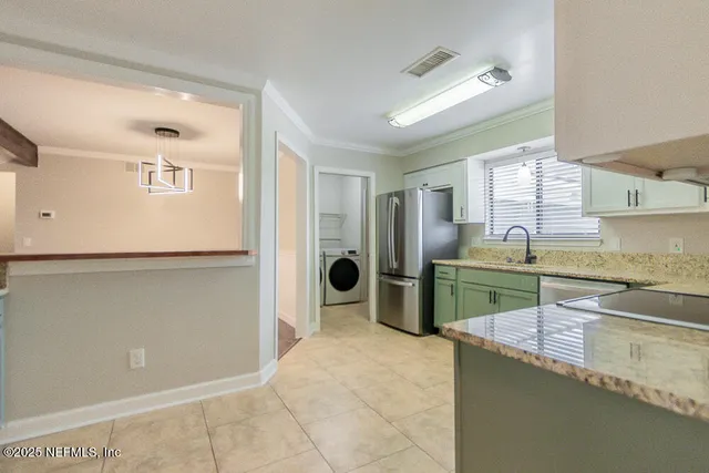 a kitchen with stainless steel appliances granite countertop a sink and a stove top oven