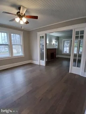 a view of a livingroom with a ceiling fan and window