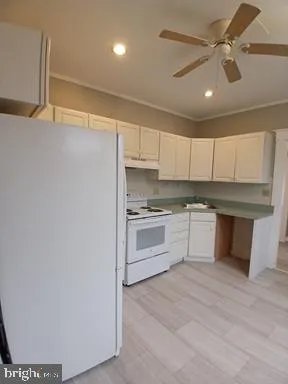 a kitchen with granite countertop white cabinets and white appliances