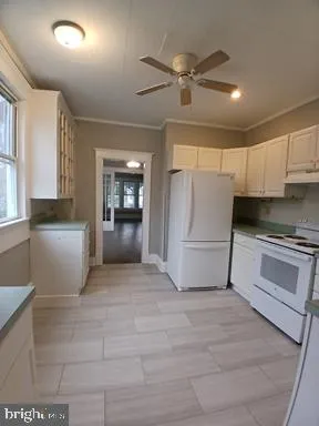 a view of a kitchen with a sink and dishwasher cabinets