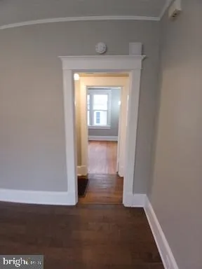 a view of hallway with wooden floor