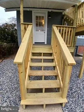 a view of entryway with wooden floor and a front door