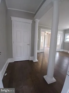 a view of a hallway with wooden floor