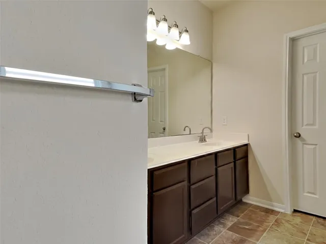 a bathroom with a sink vanity and mirror