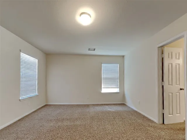 a view of an empty room and a window