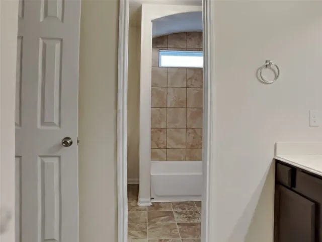 a bathroom with a glass shower door