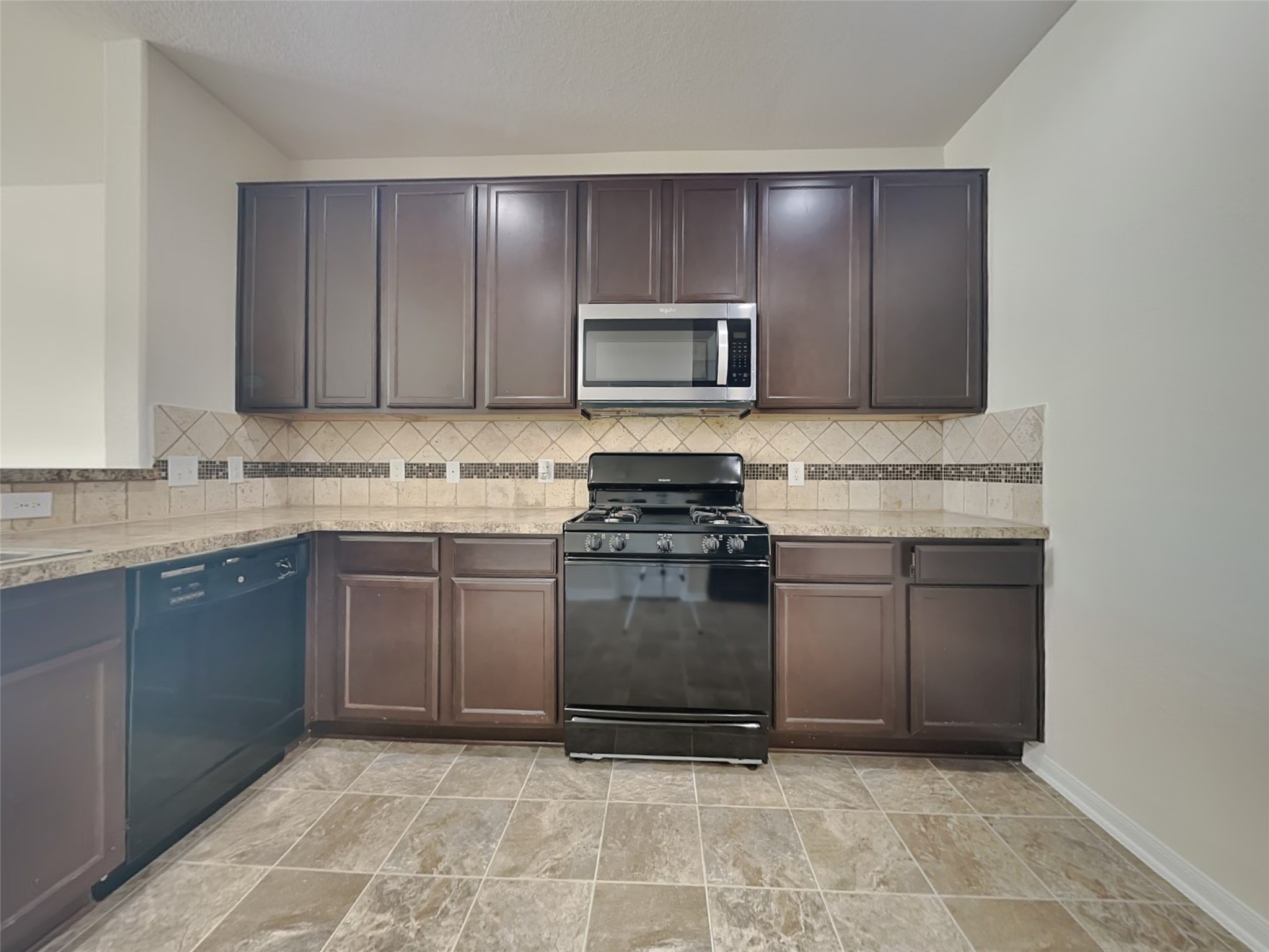 15315 Signal Ridge Way Cypress, TX 77429 - Photo 4 of 23 a kitchen with stainless steel appliances granite countertop a stove a sink and a microwave