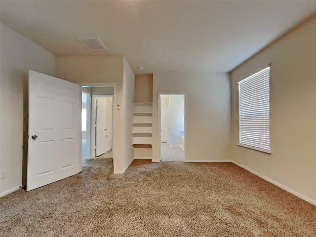an empty room with a cabinet and mirrors