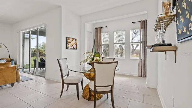 a view of a dining room with furniture and a potted plant